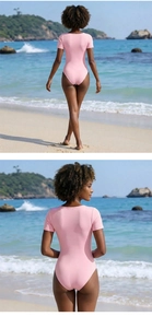 Rear view of pink square neck short sleeve swimsuit against a blue ocean background