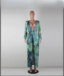 Detail view of the deep V-neck and tropical leaf print on this long summer dress