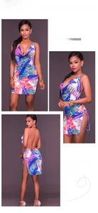 Detailed views of a tropical print halter mini dress with an open back and high side slit