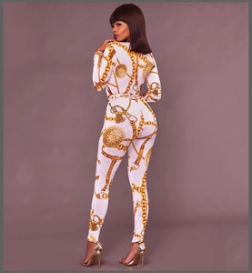 Detail view of white bodysuit with intricate gold chain and medallion pattern print