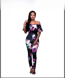 Detail of floral print jumpsuit featuring black fabric with pink and green flower pattern