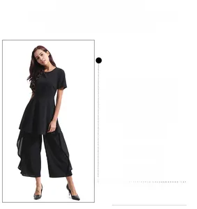 Detail view of black high-waisted wide-leg jumpsuit with short sleeves and flowing fabric
