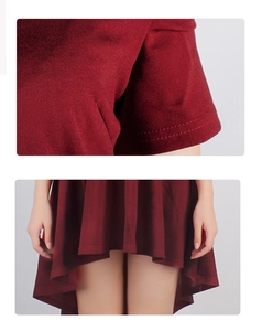Détail de la robe bordeaux avec manches à double couture et ourlet asymétrique chic