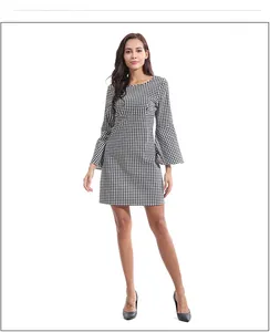 Detail of the houndstooth dress featuring classic flared long sleeves and a slim fit cut