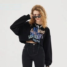 Close-up of black cropped sweatshirt with artistic text prints and street style details