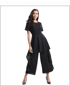 Detail view of high-waist wide-leg trousers and flared short-sleeve top in black chiffon