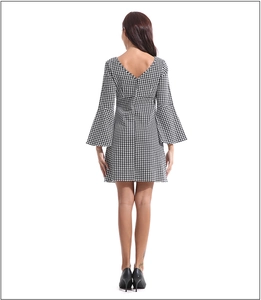 Detailed back view of a houndstooth dress featuring bell sleeves and a V-cut neckline