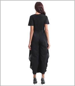 Detail view of the back layered design on a black short sleeve jumpsuit with a wide-leg cut