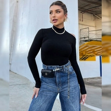 Detail showing high turtleneck and stylish shoulder cutout on black knit top