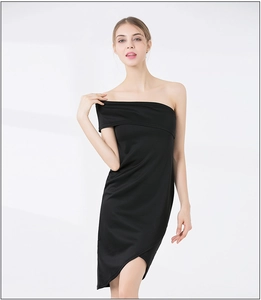 Detail of elegant black one-shoulder dress with folded neckline and asymmetric hemline