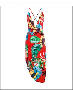 Detail of tropical print dress featuring deep V-neck, side ruching and asymmetric hemline