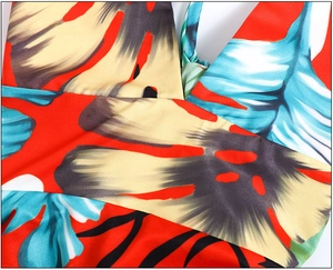 Detailed view of the tropical floral print and V-neck crisscross tailoring on the dress