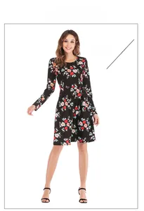 Detail of a floral long-sleeved midi dress with a cinched waist and orange flower print