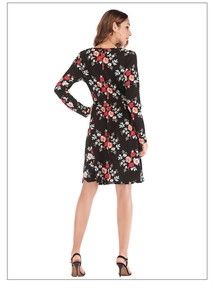 Detail view of the back of a black floral mini dress with red flower prints and slim waist