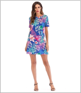Detailed view of the tropical floral print and lightweight fabric on blue summer dress