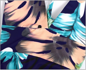 Detail of tropical palm leaf print on V-neck dress with high-quality stitching