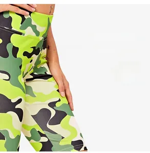 Detail view of high-waist camo yoga shorts with vibrant green digital printing