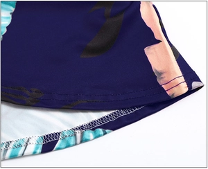 Detail view of double-stitched hem and floral print on navy knit summer dress