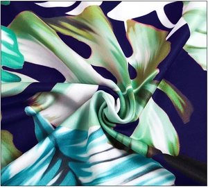 Detail of tropical palm leaf print fabric with smooth texture and vibrant colors