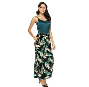 Deep green satin camisole with tropical leaf print wide-leg pants for summer elegance