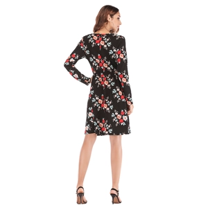 Black long-sleeved floral dress with red and blue flower patterns from a back full-body view