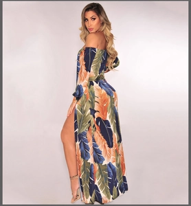 Detail view of the tropical palm leaf print and high side slit on this off-shoulder maxi dress