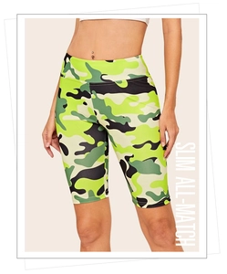 Detail of high waist camo yoga shorts with slim fit design and green camouflage pattern
