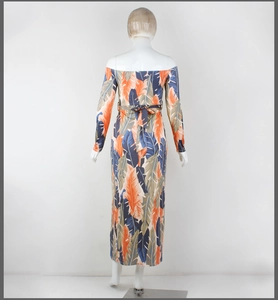 Back view of tropical palm leaf print maxi dress with tie-waist belt on a mannequin