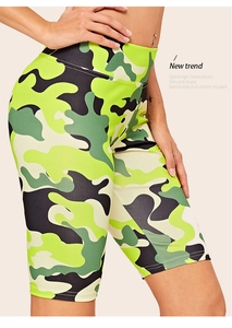 Detail view of high-waisted camo biker shorts featuring green camouflage pattern and slim fit