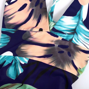 Tropical leaf print summer dress with deep V-neck and crisscross bodice detail