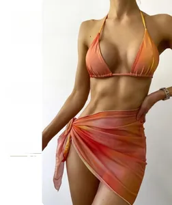 Detail of a bright orange gradient bikini set with matching mesh wrap skirt