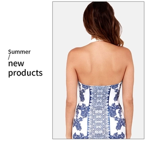 Detail of the backless halter design and blue floral print on this slim summer dress