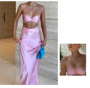 Detail of pink satin two-piece dress showing smooth silk texture and knotted crop top