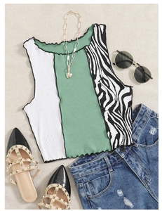 Flat lay of a striped color-block knit crop top with zebra print and ruffle edges