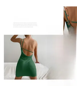 Detail view of dark green bodycon dress featuring open back and asymmetric split hem design