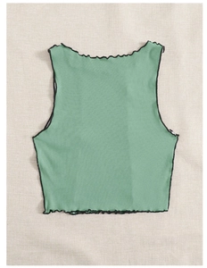Flat lay of a mint green ribbed knit crop top with black lettuce edge trim details
