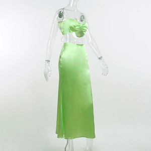 Detail of lime green satin two-piece dress with cropped camisole and long skirt texture