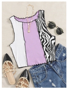 Detailed flat lay of cropped knit camisole with zebra print and ruffle trim edges