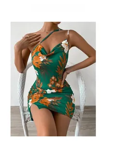 Detailed view of backless bodycon dress featuring tropical floral print and side slit
