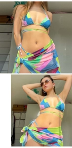 Detailed view of 3-piece bikini set with vibrant geometric print and mesh sarong skirt
