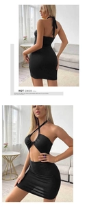 Detail view of black bodycon halter dress featuring cross straps and hollow chest cut-out