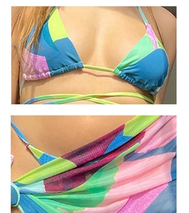 Detail shot of a three-piece tie-dye bikini set with a vibrant geometric mesh skirt cover-up
