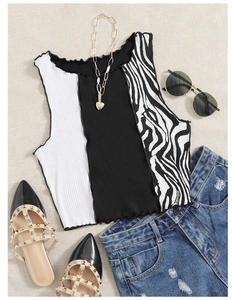 Detailed flat lay of striped knit crop top with black and zebra pattern textures