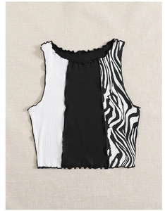 Detailed view of color-block knit crop top with patchwork zebra print and lettuce trim