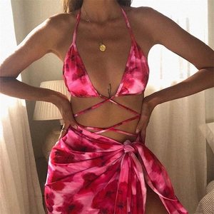 Detail of pink tie-dye three-piece bikini set with matching mesh wrap skirt for beachwear