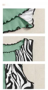 Detail showing green ribbed knit fabric with zebra pattern and ruffled black edges