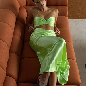 Neon green satin two-piece evening set featuring a crop top and high-waisted slim maxi skirt