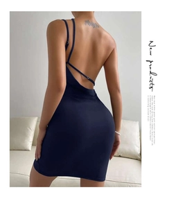 Detail view of backless navy blue bodycon dress with crisscross straps and slim fit design