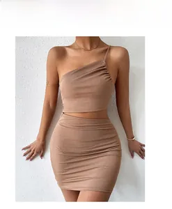 Detail shot of camel ribbed knit fabric showing ruching texture on a bodycon skirt