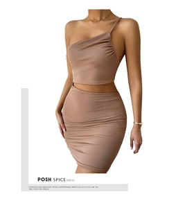 Detail of ribbed knit texture on earth-toned one-shoulder crop top and mini skirt set